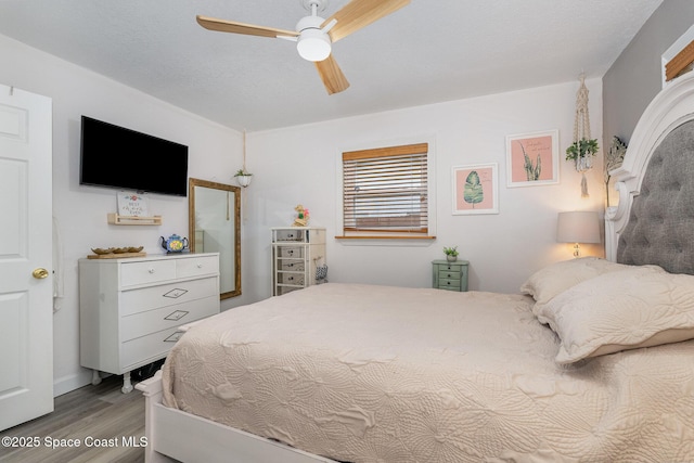 bedroom featuring hardwood / wood-style floors and ceiling fan