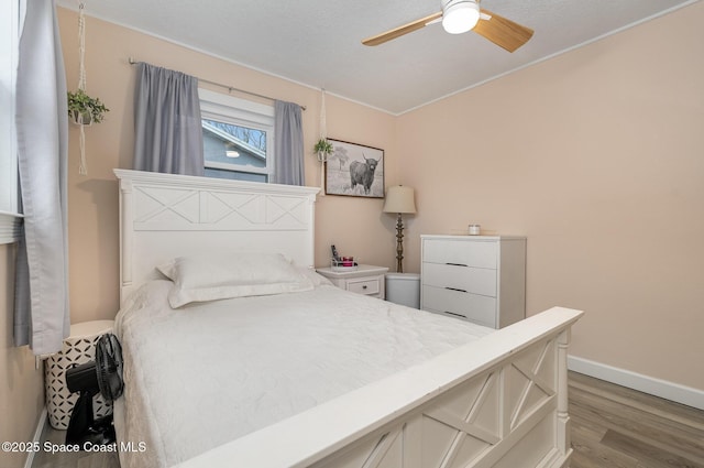 bedroom featuring ceiling fan and hardwood / wood-style flooring