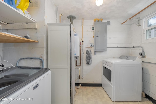 washroom with tankless water heater, electric panel, and washing machine and dryer