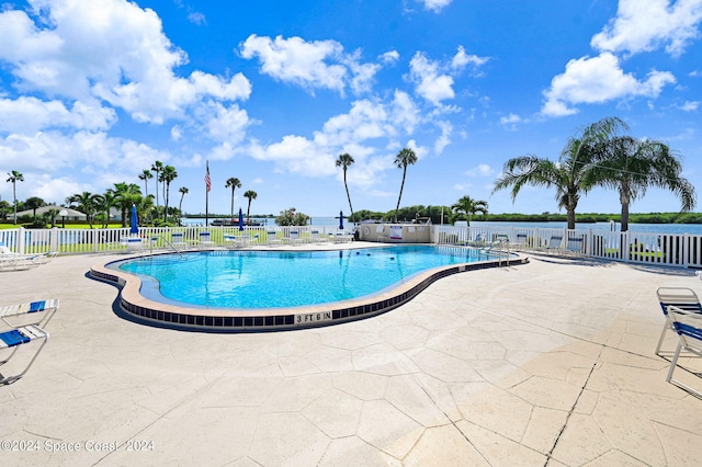 community pool featuring a patio and fence