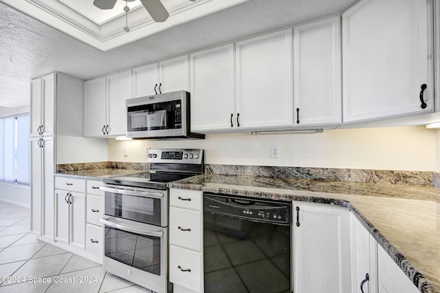 kitchen with light tile patterned floors, appliances with stainless steel finishes, a textured ceiling, white cabinetry, and a ceiling fan