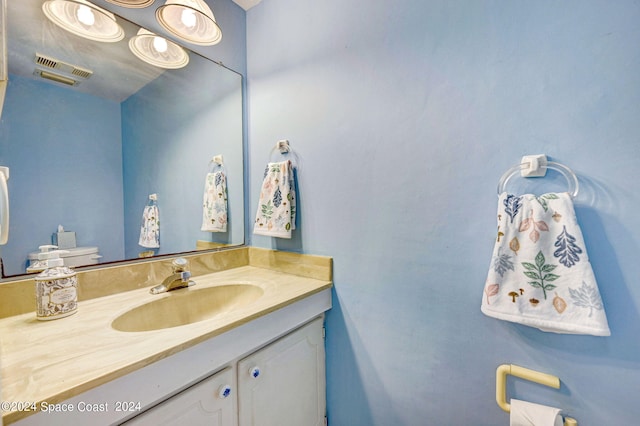 bathroom with vanity and visible vents