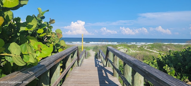 surrounding community featuring a beach view and a water view