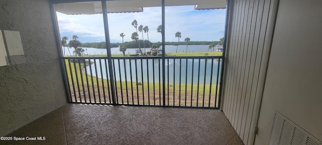 balcony with visible vents and a water view