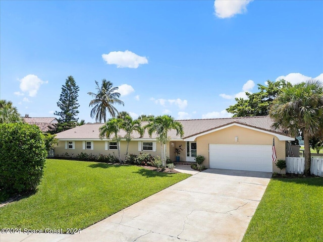 ranch-style home with a garage and a front lawn