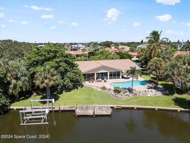 rear view of house featuring a patio area and a water view