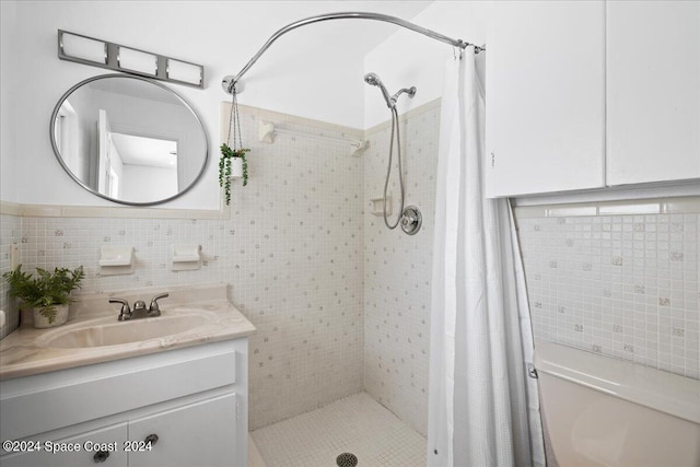 bathroom with walk in shower, vanity, toilet, and tile walls