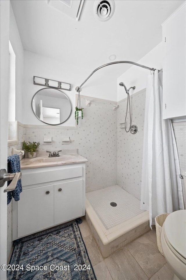 bathroom featuring vanity, toilet, tile patterned floors, and walk in shower