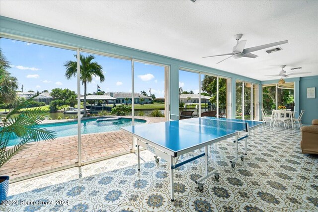 view of swimming pool featuring a patio and ceiling fan