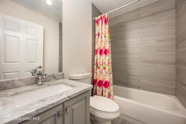 full bathroom featuring vanity, toilet, a textured ceiling, and shower / bath combo with shower curtain