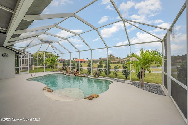 view of swimming pool featuring a patio, a lanai, and a yard