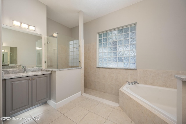 bathroom featuring vanity, independent shower and bath, and tile patterned flooring