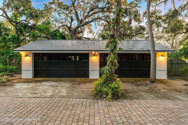 ranch-style home featuring a garage and an outbuilding