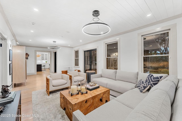 living room with crown molding, light hardwood / wood-style flooring, and wooden ceiling