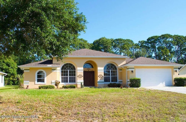 view of front of home featuring a garage and a front yard