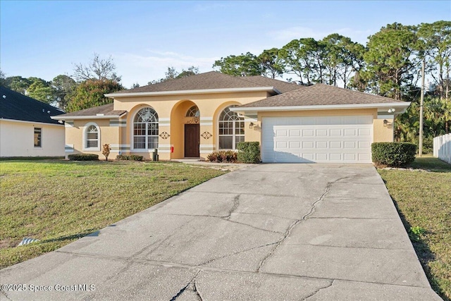 view of front of property featuring a garage and a front lawn