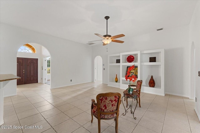 interior space featuring built in features, ceiling fan, and light tile patterned flooring