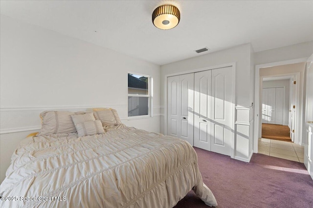 carpeted bedroom with a closet