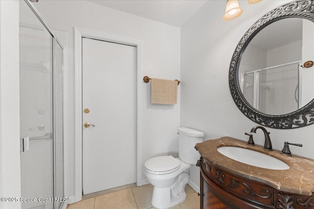 bathroom featuring tile patterned floors, vanity, toilet, and an enclosed shower