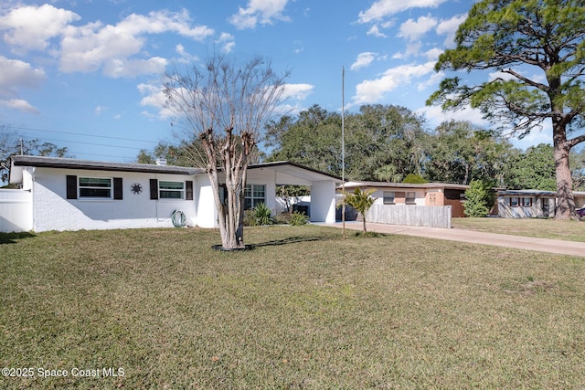 ranch-style house with a front yard and a carport