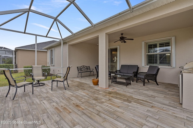 deck with ceiling fan, glass enclosure, and outdoor lounge area