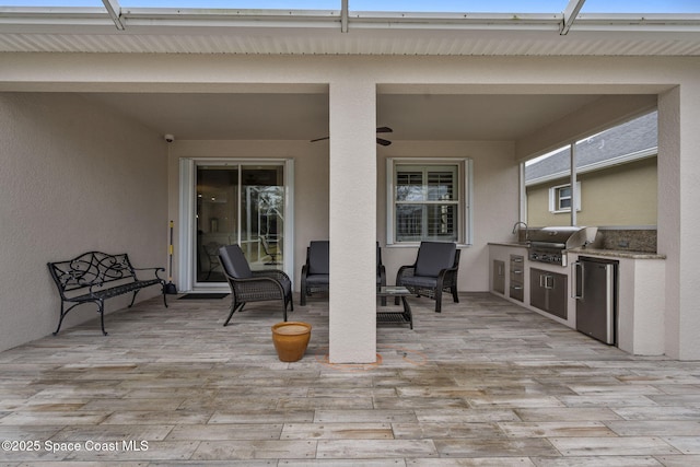 view of patio / terrace with an outdoor kitchen, grilling area, and ceiling fan