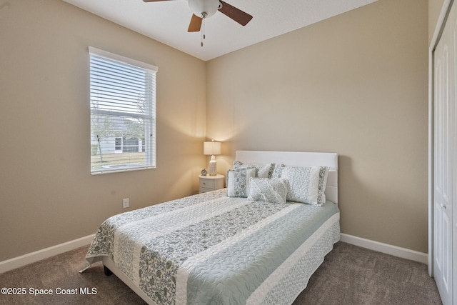 carpeted bedroom with ceiling fan and a closet