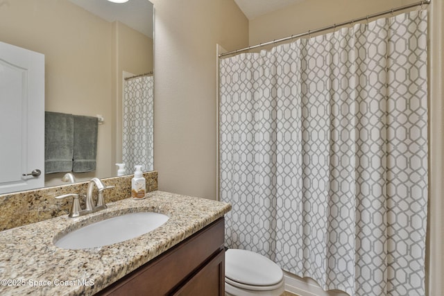 bathroom featuring toilet and vanity