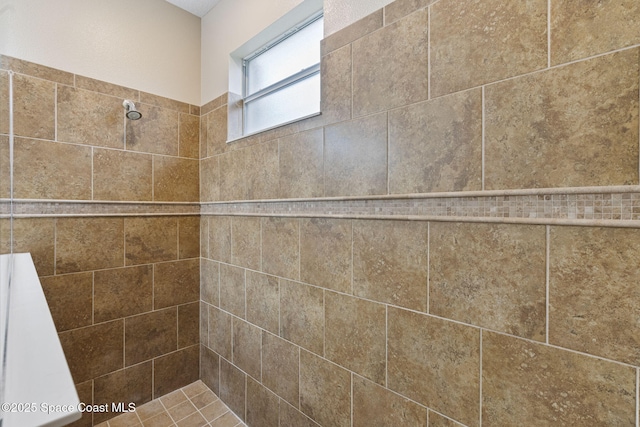 bathroom with a tile shower