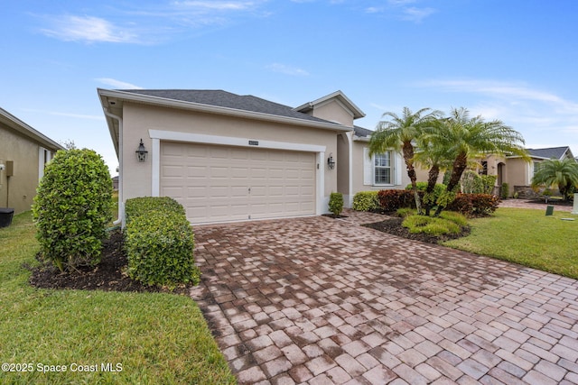 view of front of property with a garage and a front lawn