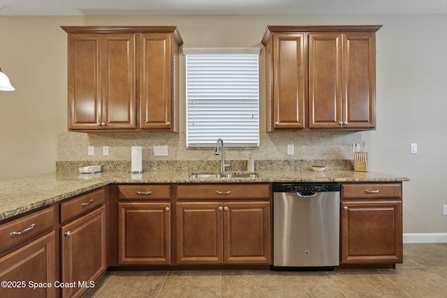 kitchen with light stone countertops, dishwasher, light tile patterned floors, decorative backsplash, and sink