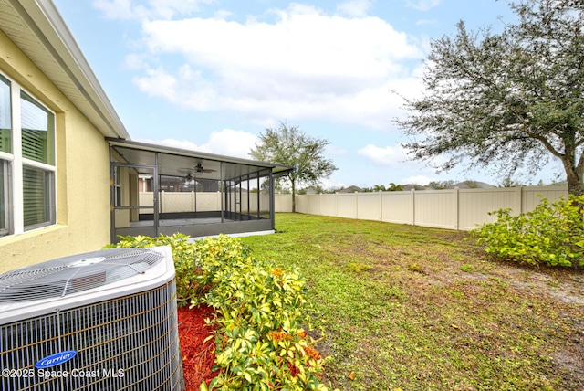 view of yard featuring central air condition unit and a sunroom