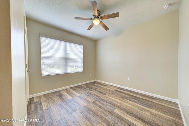 spare room with hardwood / wood-style floors, a textured ceiling, and ceiling fan