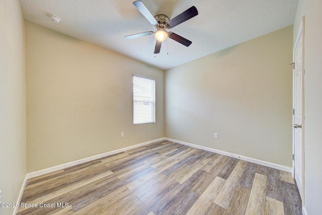 spare room featuring light hardwood / wood-style floors, a textured ceiling, and ceiling fan