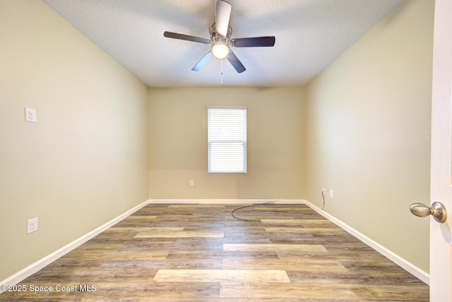 spare room with hardwood / wood-style flooring, ceiling fan, and a textured ceiling