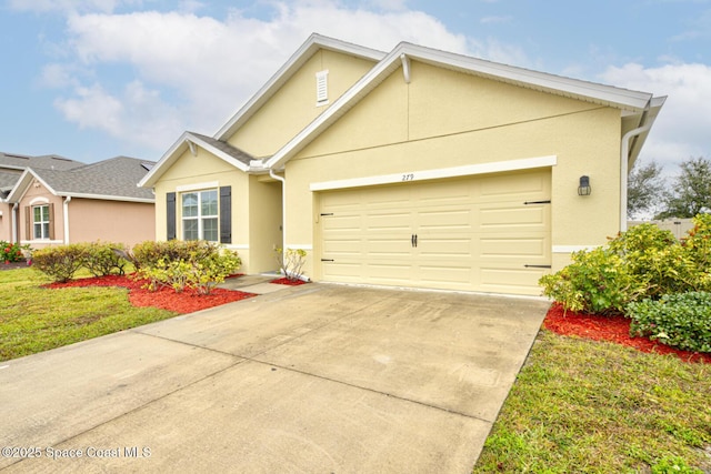 view of front of house with a garage and a front yard