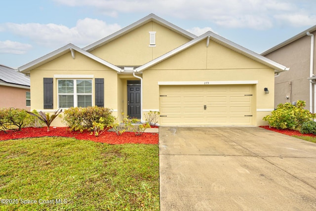 view of front of home with a garage and a front lawn