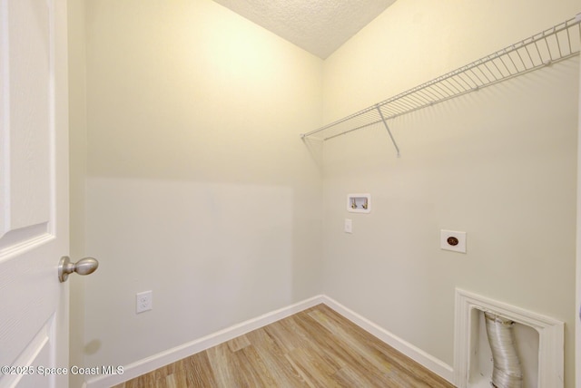 washroom with wood-type flooring, hookup for a washing machine, a textured ceiling, and hookup for an electric dryer