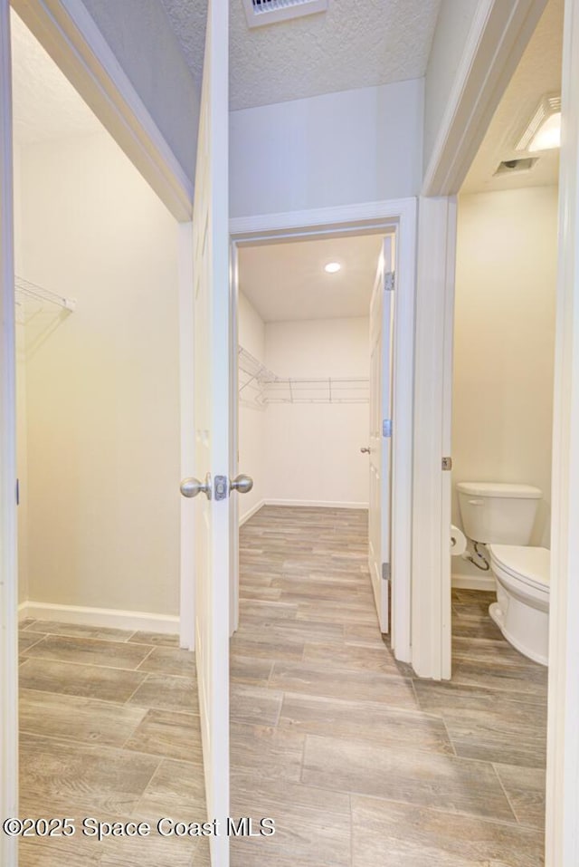 bathroom featuring toilet and a textured ceiling