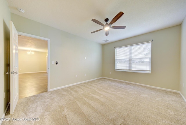 spare room featuring ceiling fan and light carpet