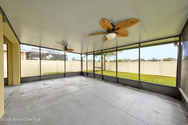 unfurnished sunroom with ceiling fan