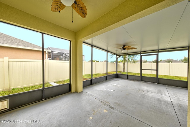 unfurnished sunroom featuring ceiling fan