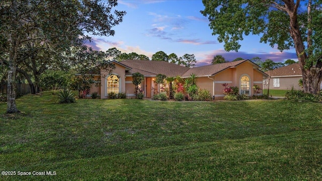 ranch-style home with a lawn