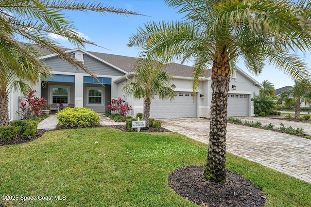 view of front of home with a garage and a front yard