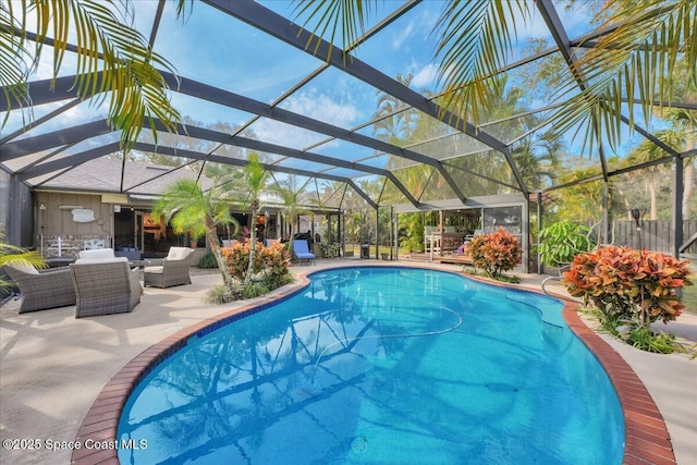 view of pool featuring an outdoor living space, glass enclosure, and a patio area