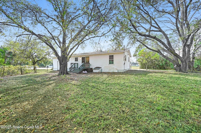 back of property featuring a lawn