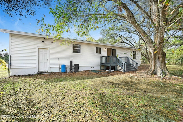 rear view of house featuring a yard