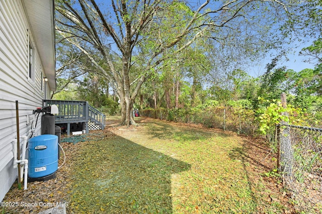 view of yard with fence and a deck