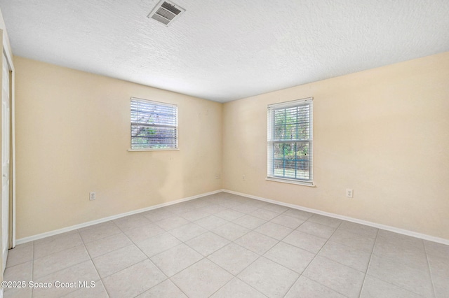 spare room featuring a textured ceiling