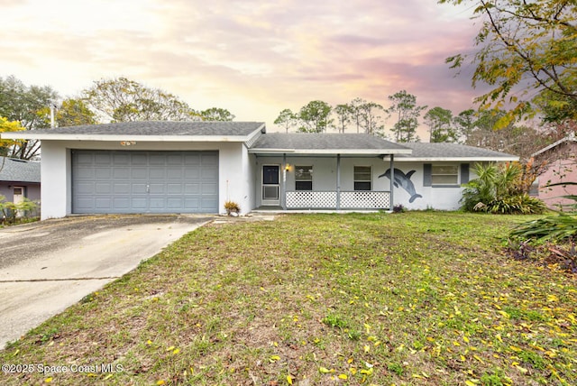 single story home featuring a garage, a lawn, and a porch